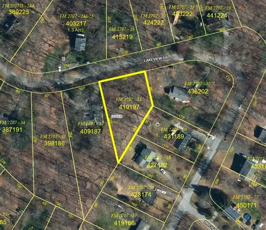 an aerial view of a residential building with an outdoor space