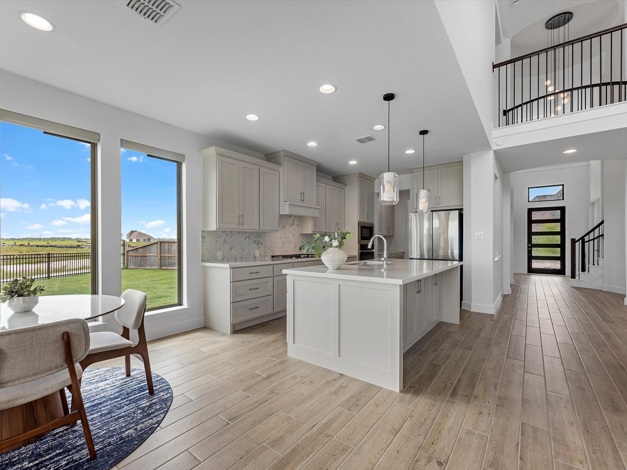 18714 Pistachio Way Manvel, TX 77578 - Photo 13 of 48 Designed for both everyday living and entertaining, this open-concept layout offers clear sightlines from the family room to the kitchen, breakfast area, and grand foyer.