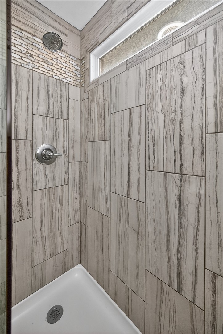 4747 Fawnwood Road Dayton, OH 45429 - Photo 43 of 58 This sleek shower showcases elegant tilework, a modern showerhead, and a translucent window for ambient light.