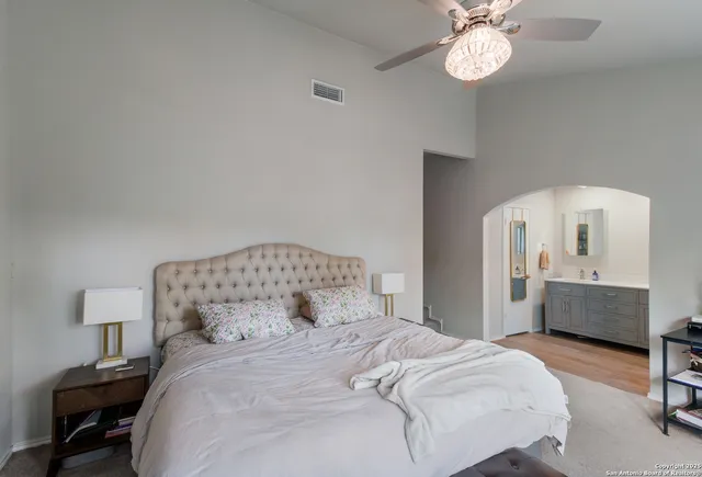 a bedroom with a bed and a chandelier