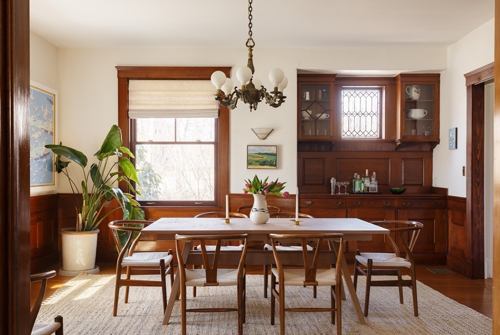 25 Barrington Road Boston, MA 02124 - Photo 13 of 33 a dining room with furniture a chandelier and wooden floor