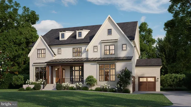 a front view of a house with a yard and trees