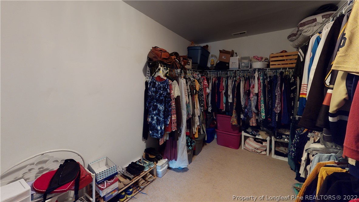 3428 Park Hill Road Fayetteville, NC 28311 - Photo 14 of 29 a view of walk in closet with clothes