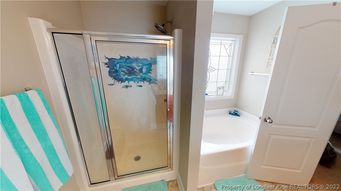 3428 Park Hill Road Fayetteville, NC 28311 - Photo 16 of 29 a bathroom with a tub and a shower