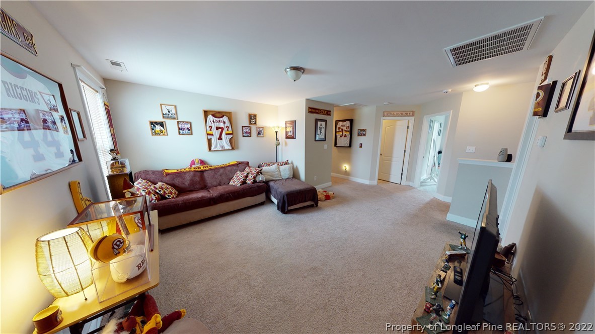 3428 Park Hill Road Fayetteville, NC 28311 - Photo 20 of 29 a living room with furniture and a flat screen tv