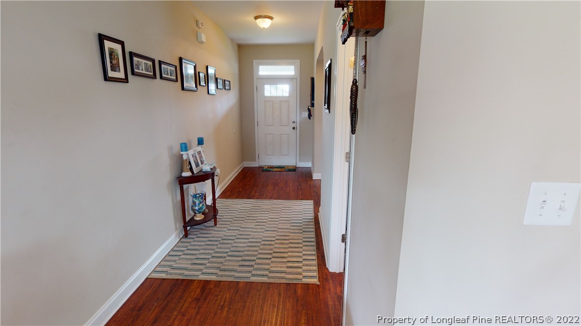 3428 Park Hill Road Fayetteville, NC 28311 - Photo 2 of 29 a view of a hallway with wooden floor and stairs