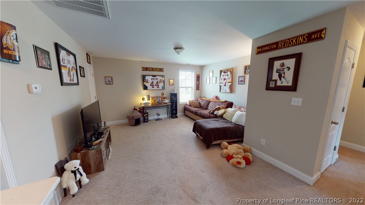 3428 Park Hill Road Fayetteville, NC 28311 - Photo 21 of 29 a living room with furniture and a gym machine