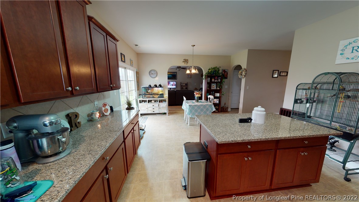 3428 Park Hill Road Fayetteville, NC 28311 - Photo 4 of 29 a kitchen with stainless steel appliances granite countertop a sink dishwasher stove and cabinets with wooden floor