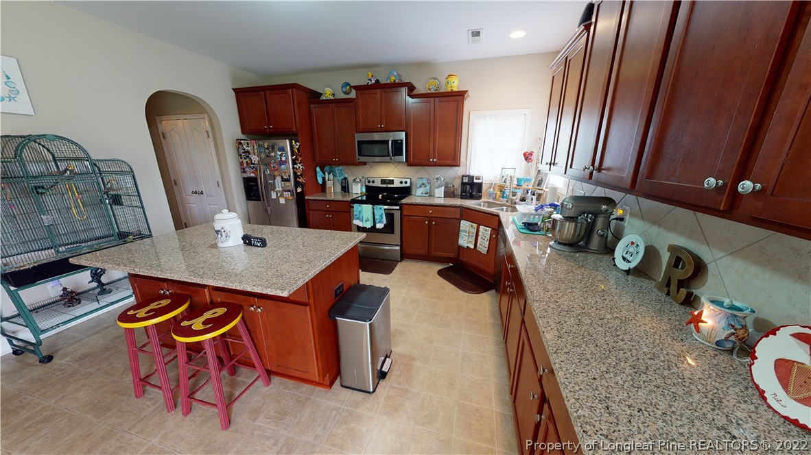 3428 Park Hill Road Fayetteville, NC 28311 - Photo 5 of 29 a kitchen with stainless steel appliances a sink a stove a refrigerator and cabinets