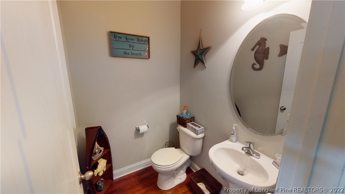 3428 Park Hill Road Fayetteville, NC 28311 - Photo 7 of 29 a bathroom with a toilet sink and mirror