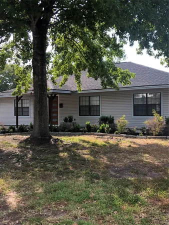 a front view of house with yard and trees