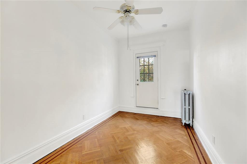 178 68th Street Brooklyn, NY 11220 - Photo 21 of 40 an empty room with a chandelier fan and windows