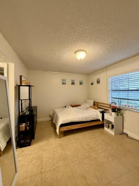 3150 Leewood Terrace, Unit L125 Boca Raton, FL 33431 - Photo 8 of 18 a spacious bedroom with a bed and large windows