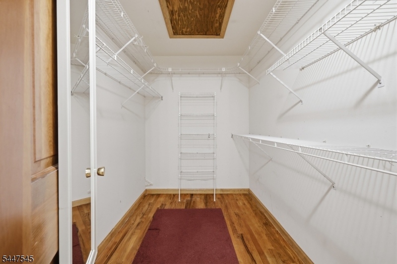 860 Glen Road Sparta, NJ 07871 - Photo 34 of 43 a view of walk in closet with wooden floor