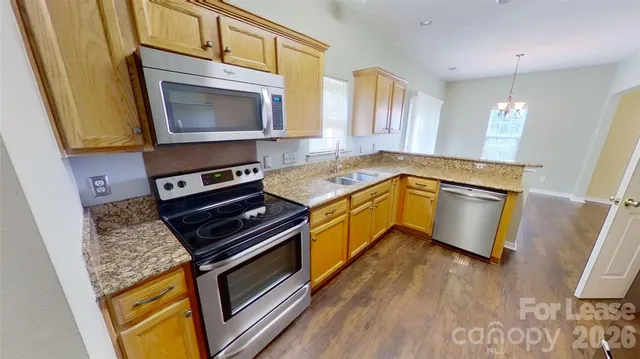 a kitchen with a sink stove and microwave