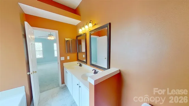 a bathroom with a bathtub sink and mirror
