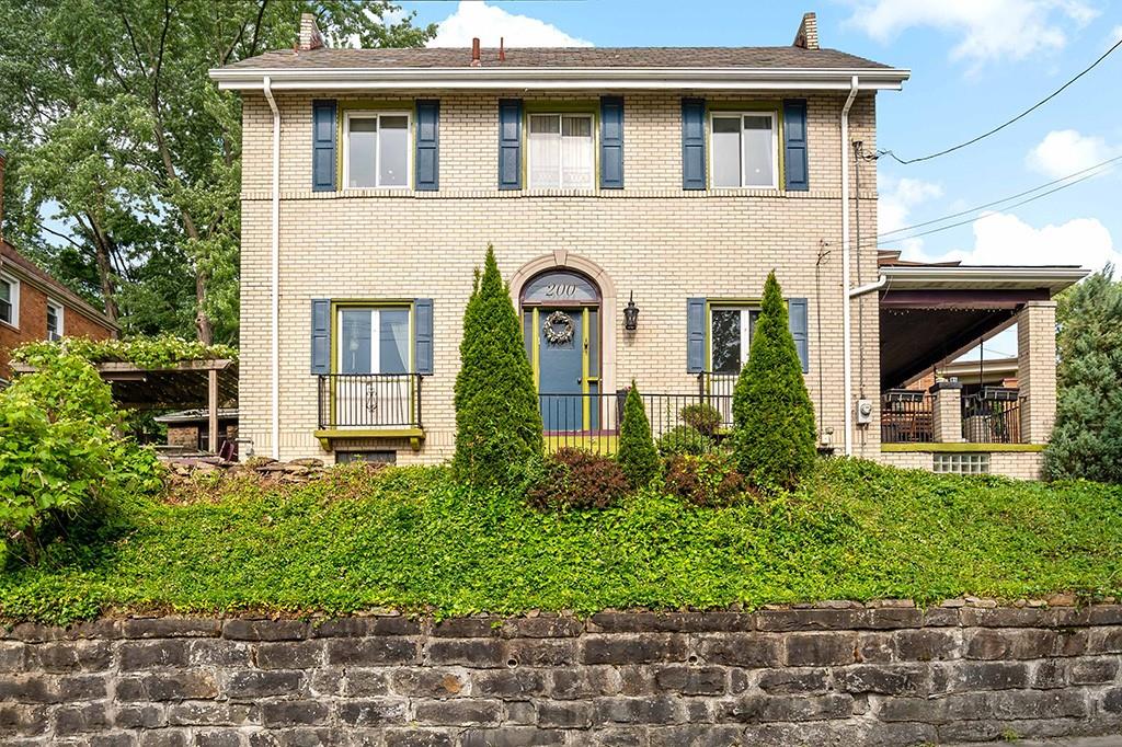 a front view of a house with a garden