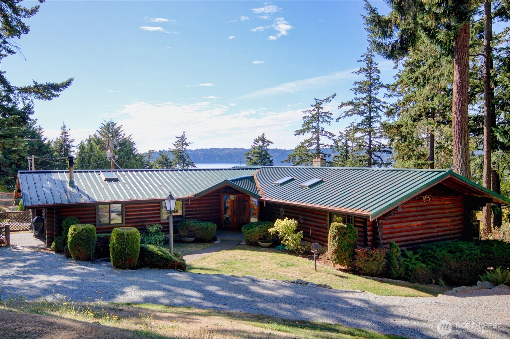 a view of a house with wooden deck and furniture