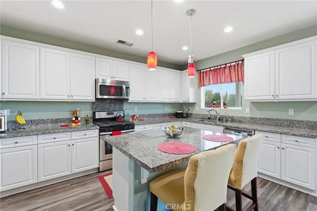 a kitchen with a stove a sink and a refrigerator