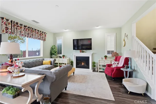 a living room with furniture flat screen tv and a fireplace