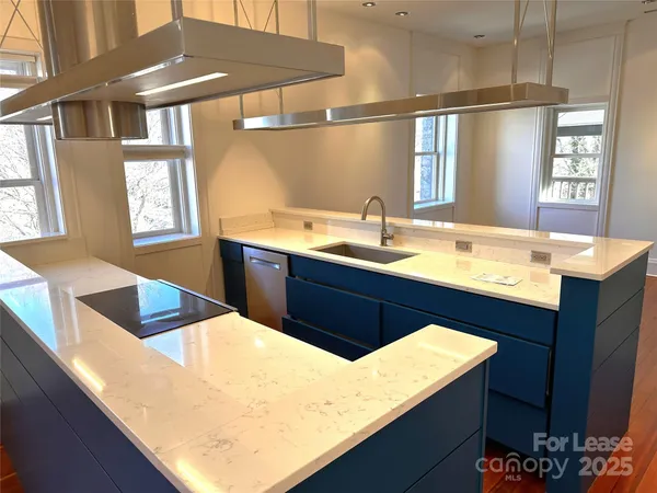 a kitchen with stainless steel appliances granite countertop a sink stove and cabinets