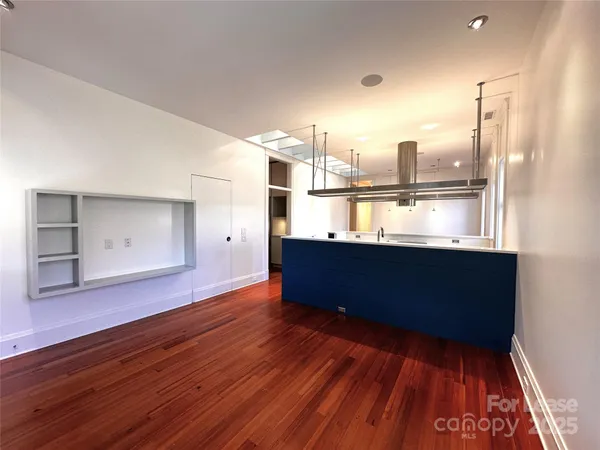 a room with hard wood floors and a view of living room
