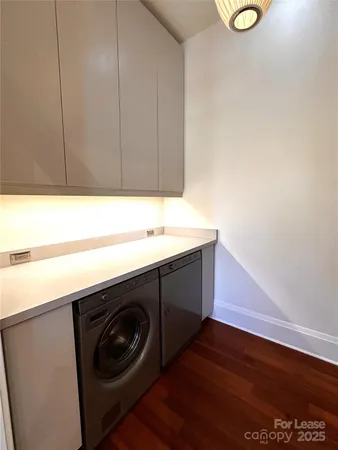 a utility room with sink dryer and washer