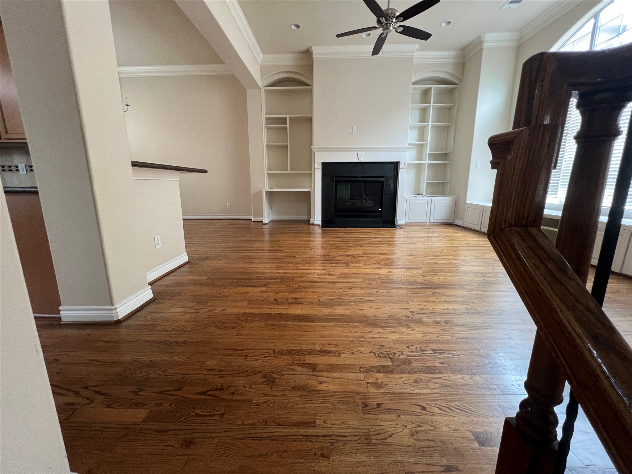 5940 Kansas Street Houston, TX 77007 - Photo 11 of 29 a view of a livingroom with a fireplace a ceiling fan and wooden floor