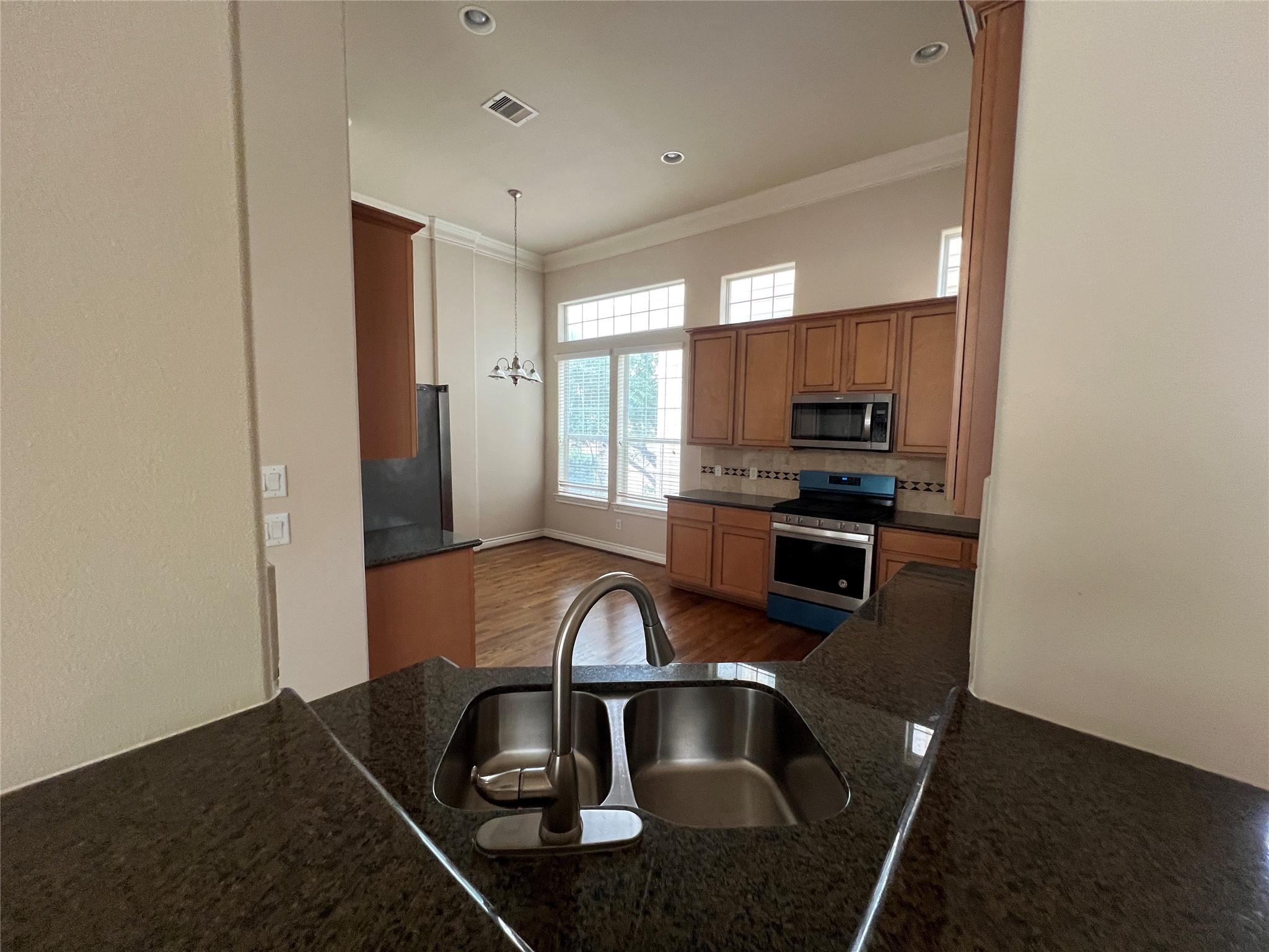 5940 Kansas Street Houston, TX 77007 - Photo 13 of 29 a kitchen with granite countertop a stove and a sink