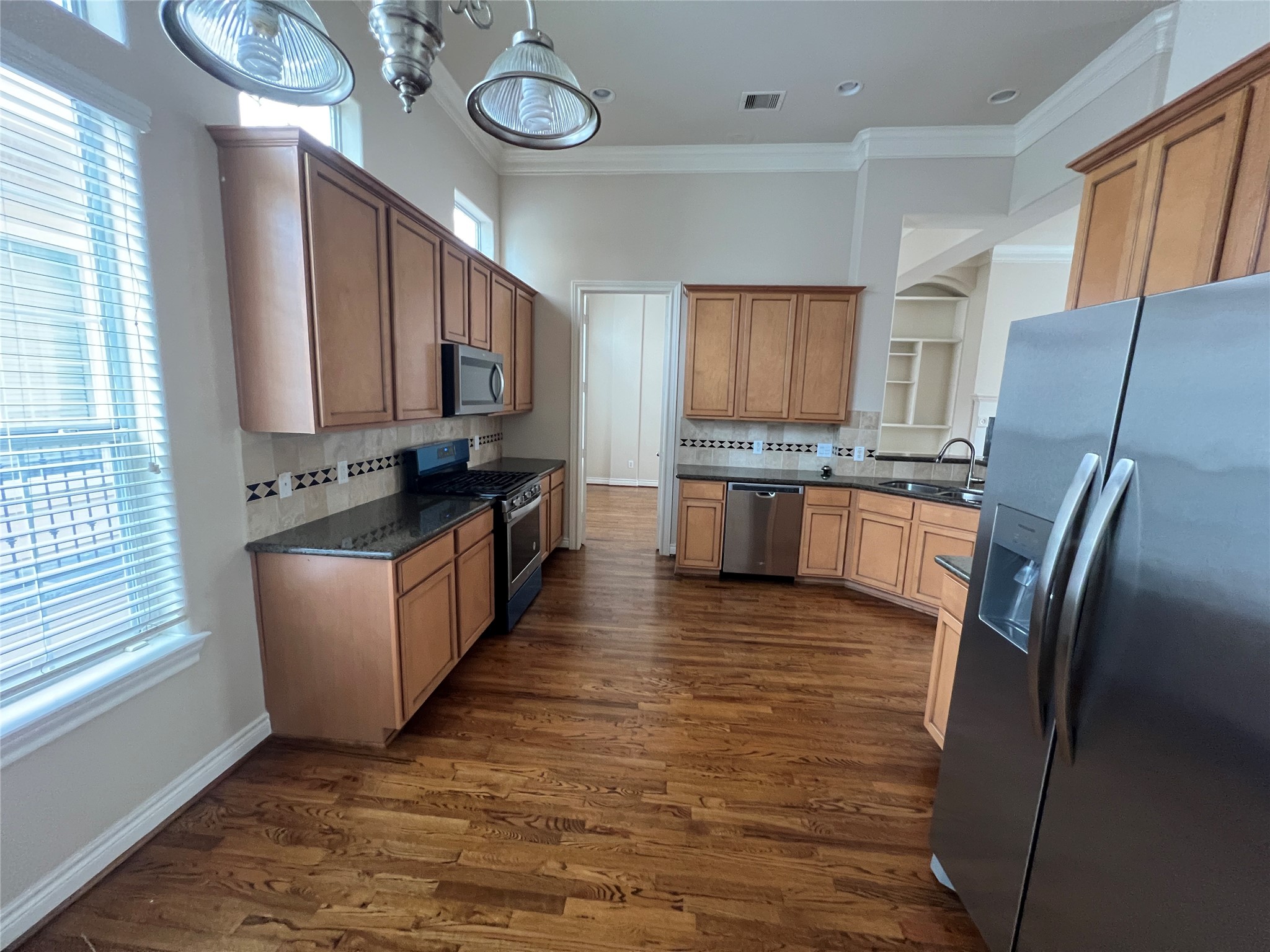 5940 Kansas Street Houston, TX 77007 - Photo 16 of 29 a kitchen with stainless steel appliances granite countertop a refrigerator a stove top oven a sink and dishwasher