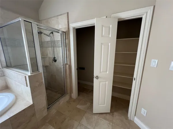 a bathroom with a shower and a sink