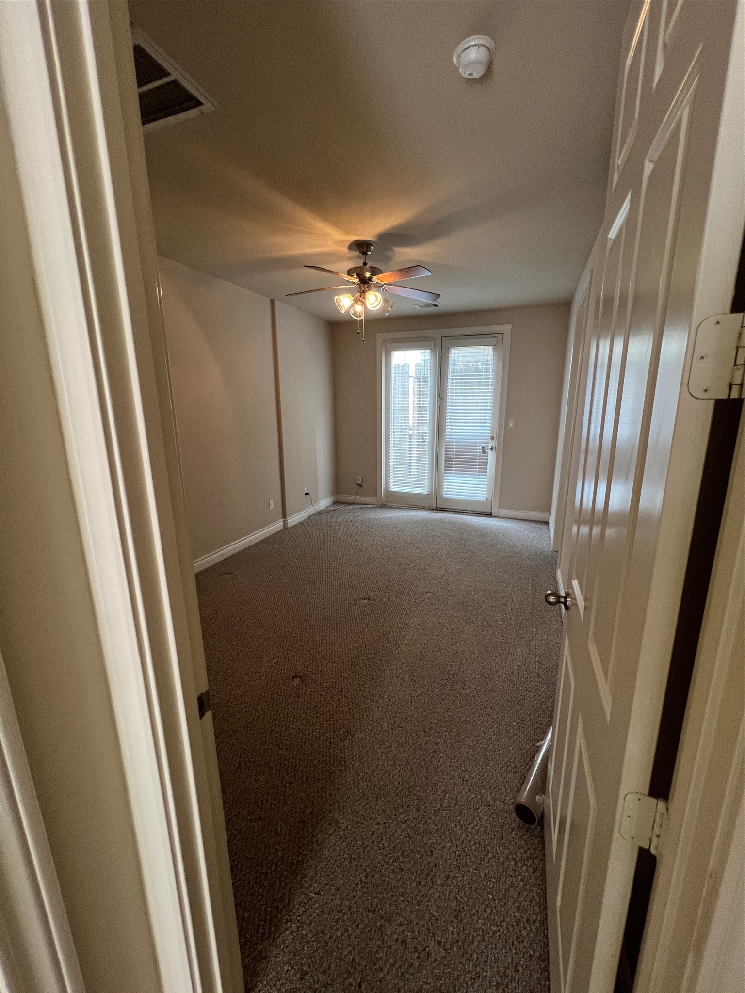 5940 Kansas Street Houston, TX 77007 - Photo 6 of 29 a view of a hallway and a chandelier fan