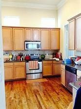 5940 Kansas Street Houston, TX 77007 - Photo 7 of 7 a kitchen with stainless steel appliances kitchen island granite countertop a stove a sink and a microwave