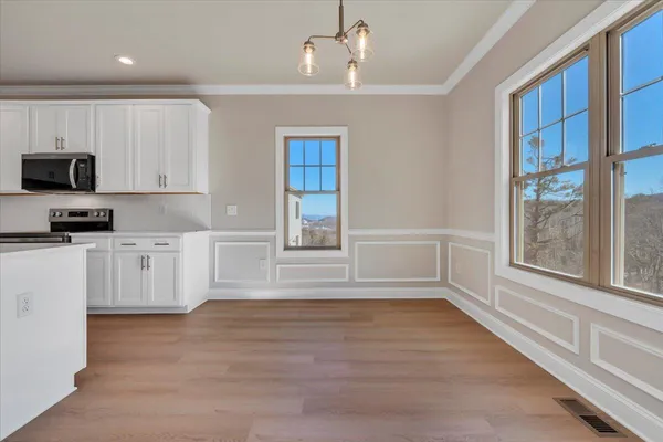 a kitchen with granite countertop a stove a sink and a refrigerator