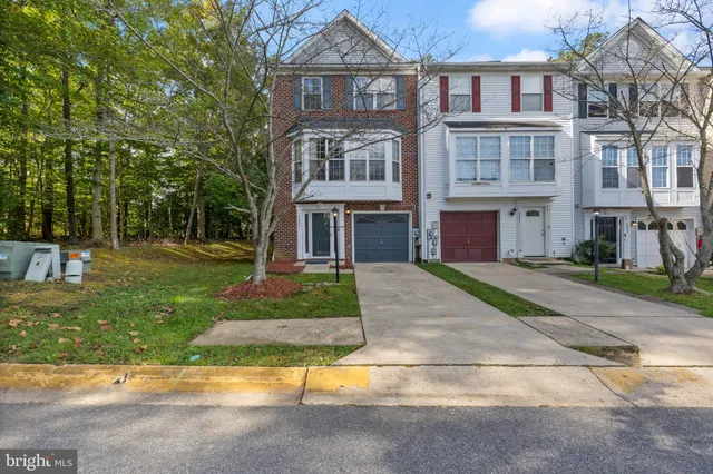 a kitchen with granite countertop a sink stove and refrigerator