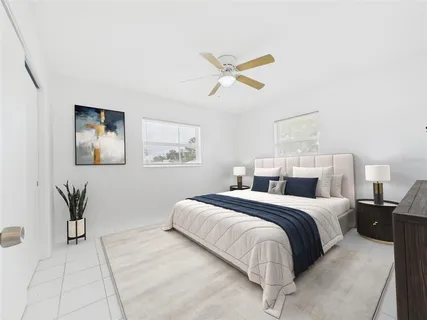 a bedroom with a bed and painting on the wall