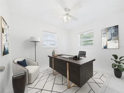 a view of a workspace with furniture and a potted plant