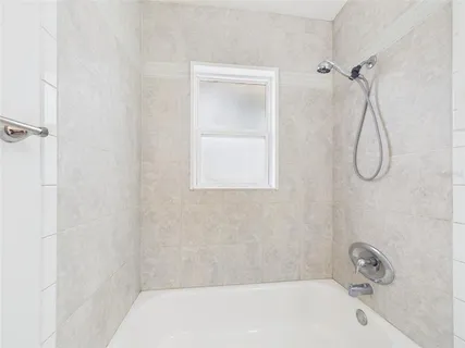 a bathroom with a bath tub with a shower
