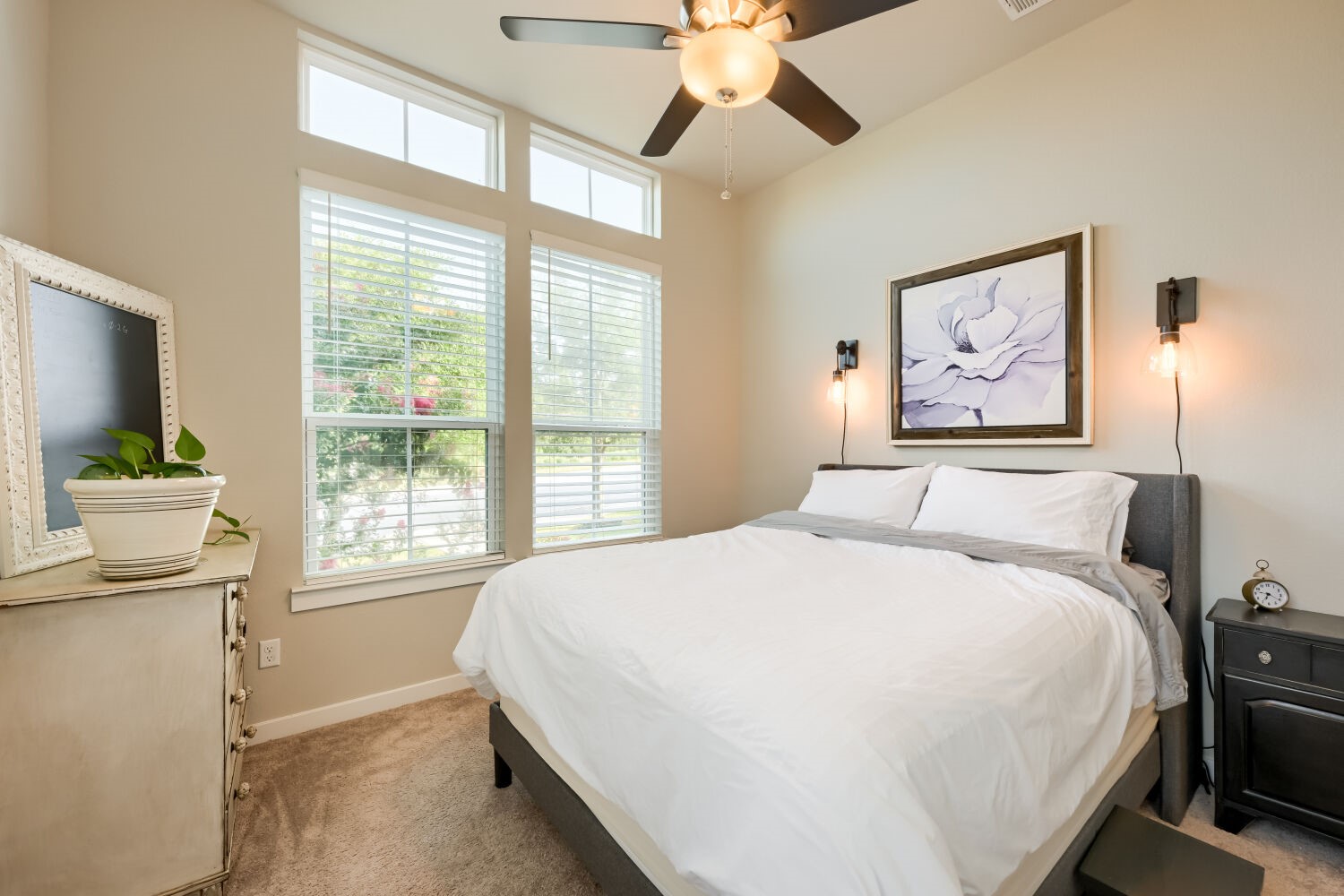 621 Rancho Sienna Loop Georgetown, TX 78628 - Photo 20 of 28 Natural light floods this primary bedroom, highlighting its vaulted ceilings and plush carpeting.
