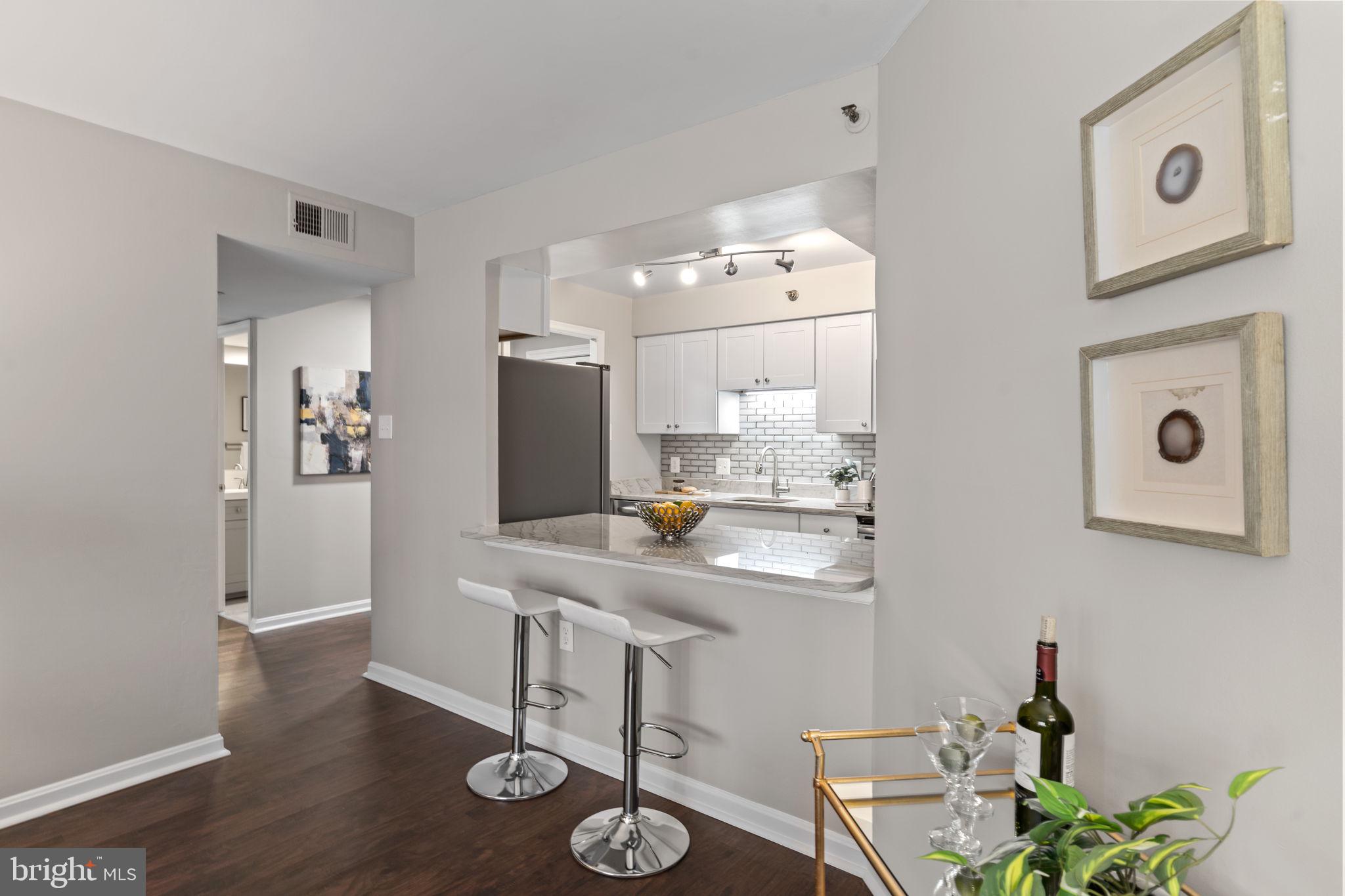 1301 North Courthouse Road, Unit 914 Arlington, VA 22201 - Photo 11 of 50 a kitchen with stainless steel appliances granite countertop a sink and a refrigerator