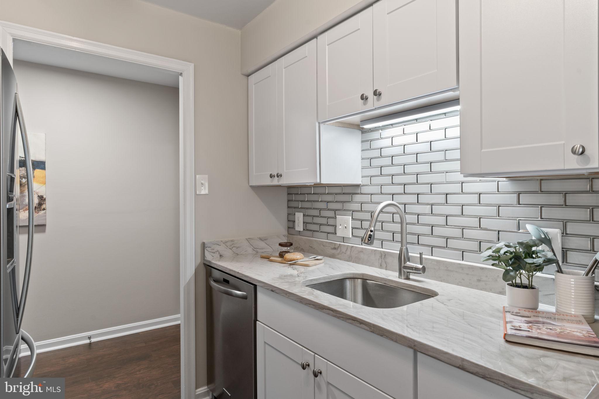 1301 North Courthouse Road, Unit 914 Arlington, VA 22201 - Photo 15 of 50 a kitchen with a sink cabinets and a window