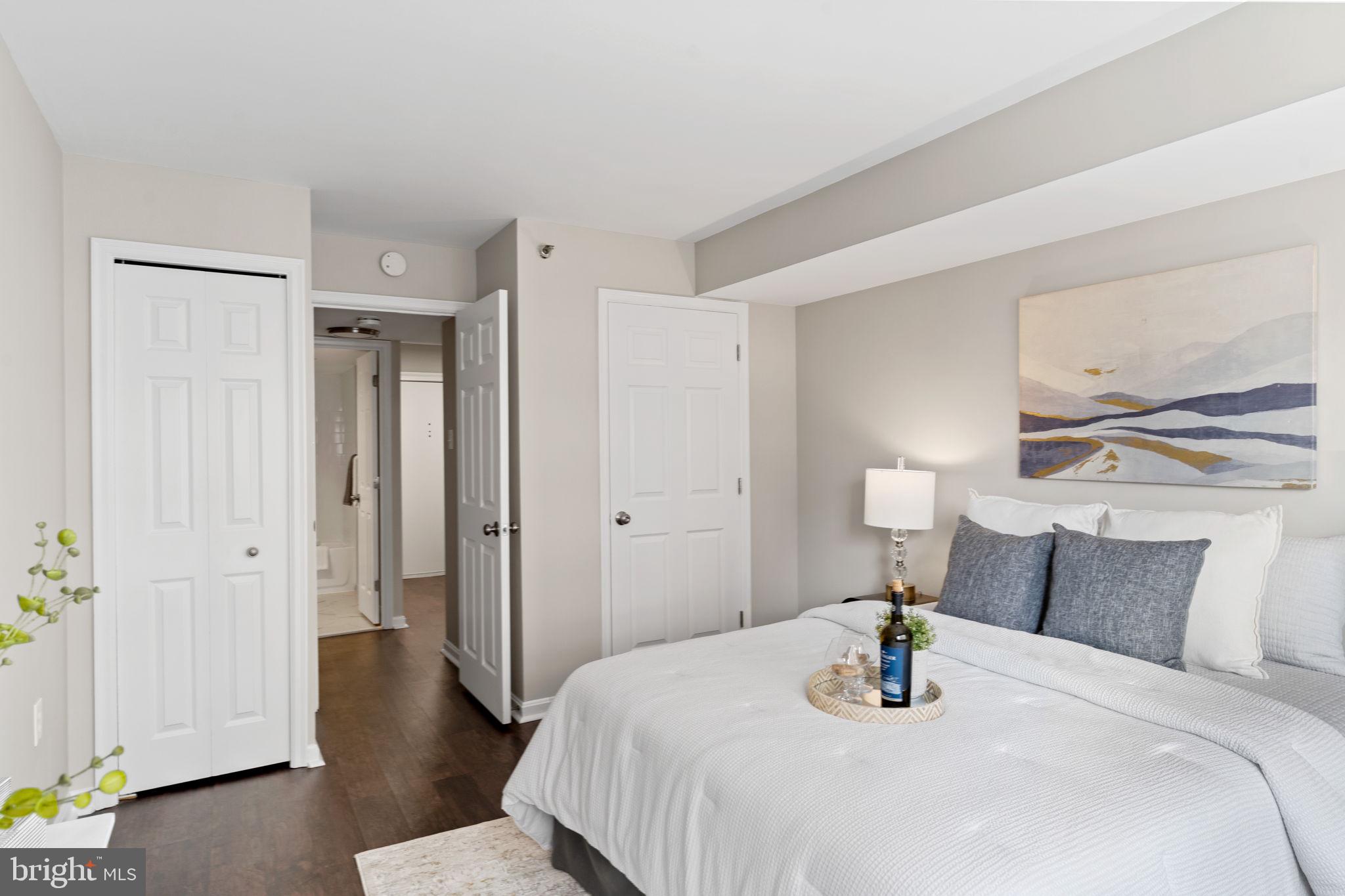 1301 North Courthouse Road, Unit 914 Arlington, VA 22201 - Photo 17 of 50 a bedroom with a bed and wooden floor