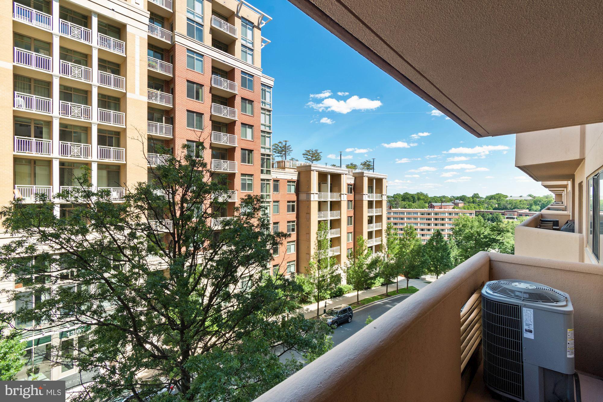 1301 North Courthouse Road, Unit 914 Arlington, VA 22201 - Photo 28 of 50 a view of balcony with floor to ceiling windows and potted plants