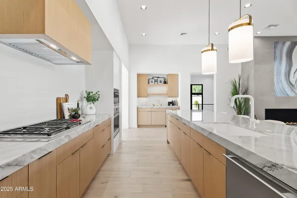 a large kitchen with stainless steel appliances kitchen island granite countertop a sink and cabinets