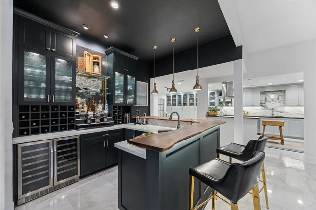 a living room with furniture a ceiling fan and a flat screen tv