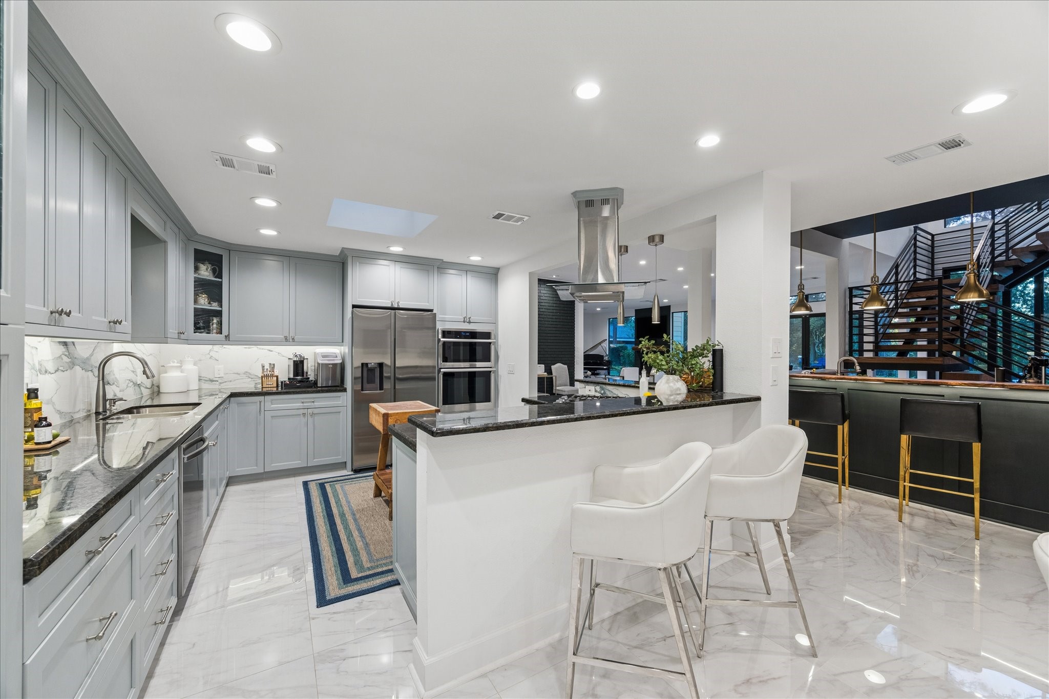45 Patti Lynn Lane Houston, TX 77024 - Photo 15 of 49 a kitchen with stainless steel appliances kitchen island granite countertop a sink and cabinets