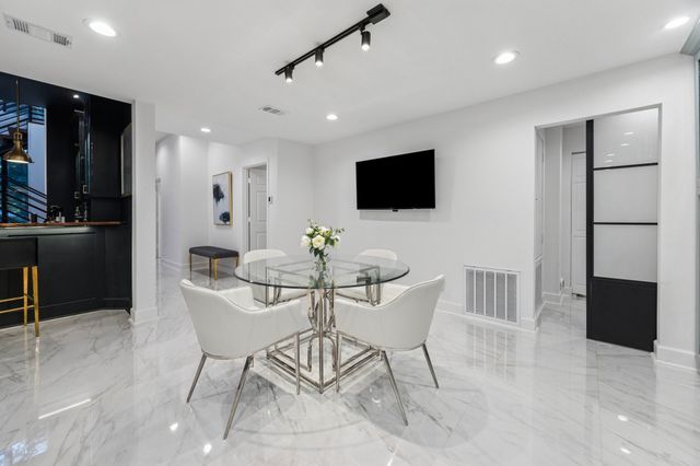a view of a balcony with wooden floor and outdoor seating