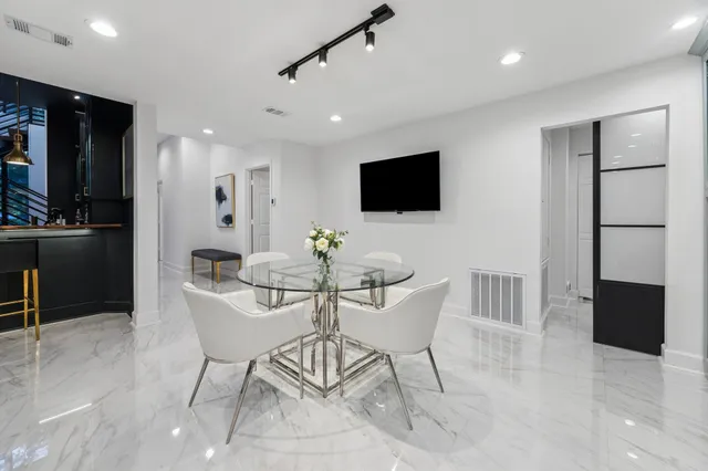 a view of a balcony with wooden floor and outdoor seating