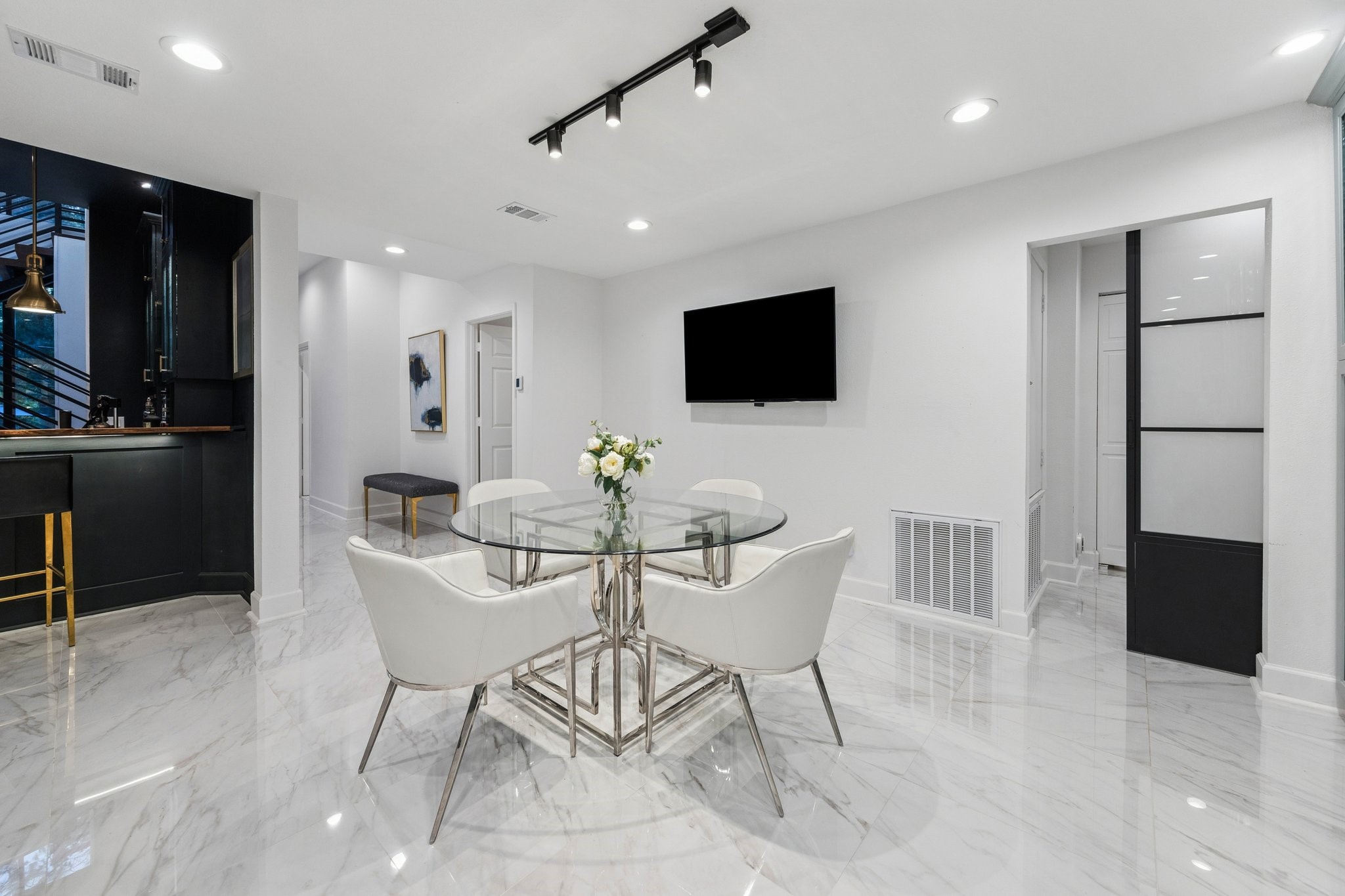 45 Patti Lynn Lane Houston, TX 77024 - Photo 19 of 49 a dining room with furniture and a flat screen tv
