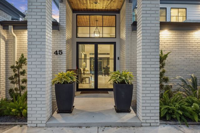 a dining room with furniture and a floor to ceiling window